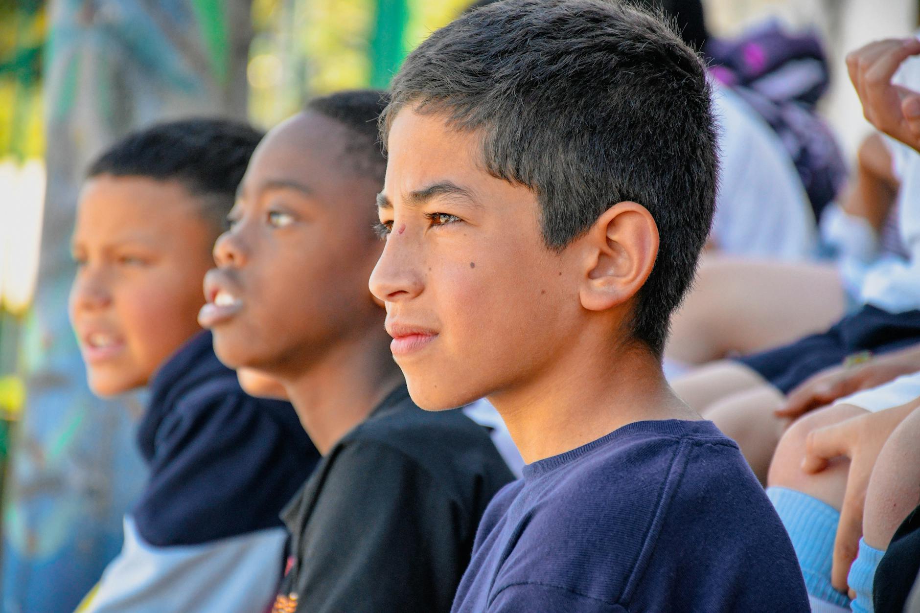 boy sitting among colleagues