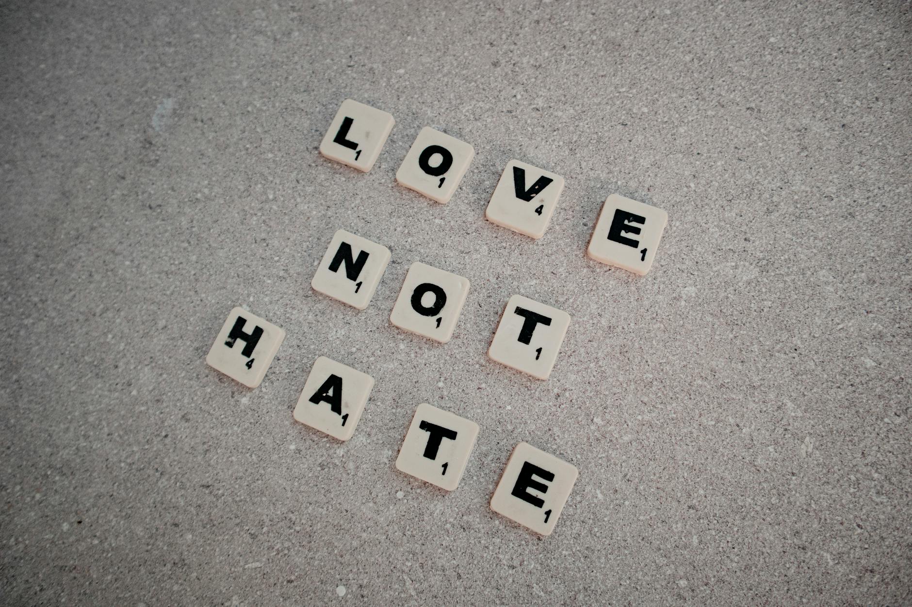 scrabble tiles spelling love not hate